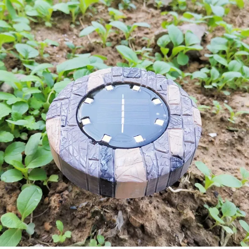 Set 4 lampi solare cu aspect de piatra cu 8 LED-uri si senzor de lumina Bell Howell